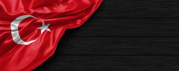 Close up of united states of Turkey flag on the black wooden background 3d render