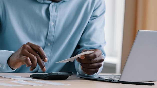 Close up unknown african man banker accountant hold payment incomes outcomes utility bills make