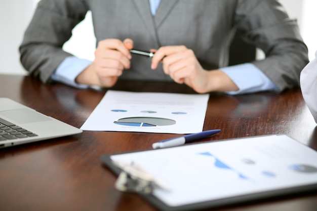 Close up  of unknown  business people at meeting discussing financial results