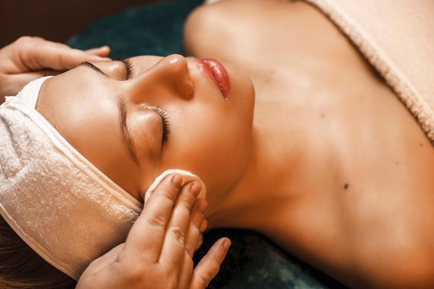 Close up upper view of a charming woman having a skin cleaning procedures in a spa salon.