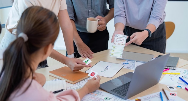 Close up ux developer and ui designer brainstorming interface wireframe designCreative digital development agency