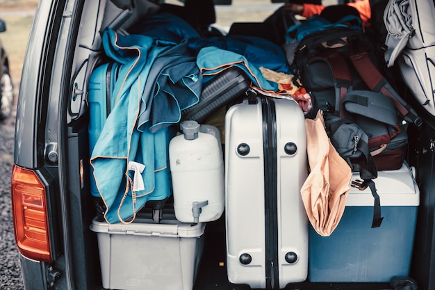 Close up of a van filled with suitcase bag and road trip stuff ready to start the route traveling across iceland Sleeping outdoors camping and exploring concepts Copy space Image