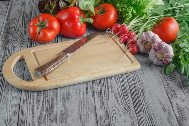 Close up of various vegetables on wooden cutting board