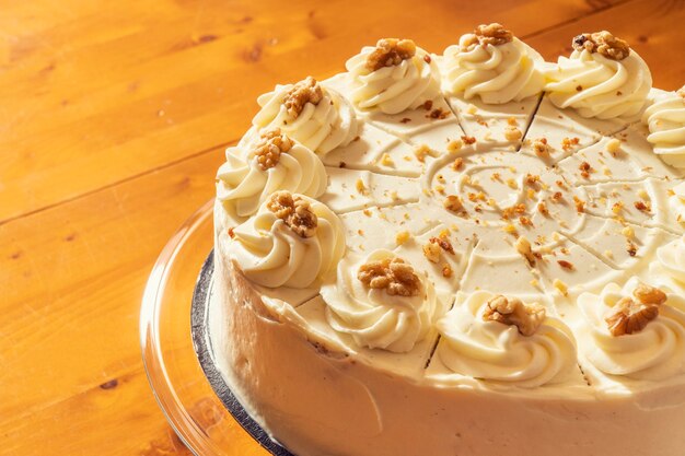 Close up view of an almond and vanilla cake on a wooden table