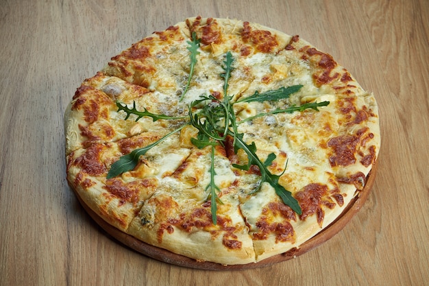 Close up view on Appetizing 4 cheese pizza with pear on wooden table in a restaurant. Pizza in composition. Italian cuisine. Food flat lay