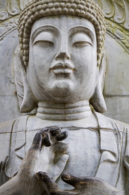 Close up view of a beautiful Buddha statue on a park.