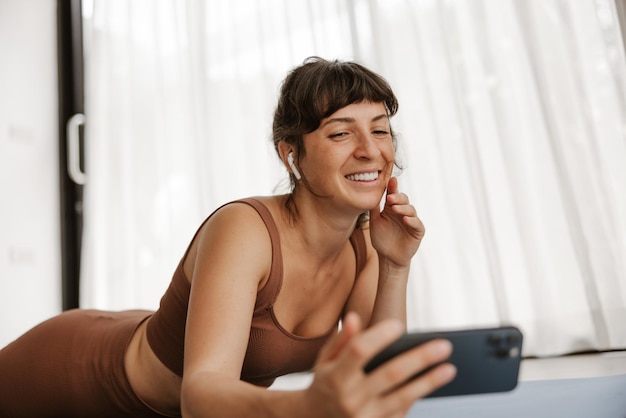 Close up view of brunette sportswoman doing selfie on phone