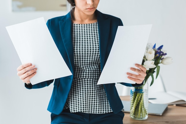 Close-up view of business documents in female hands