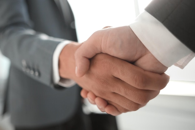 Close up view of business partnership handshake conceptPhoto of two businessman handshaking processSuccessful deal after great meeting