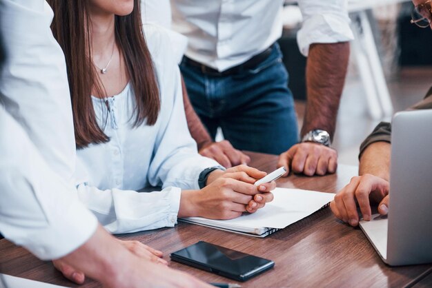 Close up view of business people that sitting and working together in the modern office.