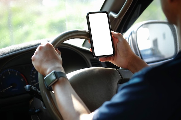 Close up view businessman sitting in car and using smart phone Blank screen for your advertising text