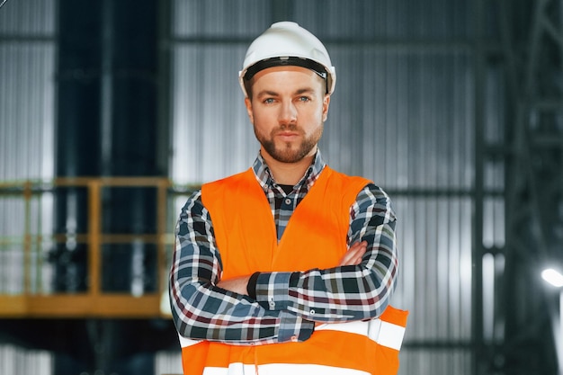 Close up view Construction worker in uniform is in the factory