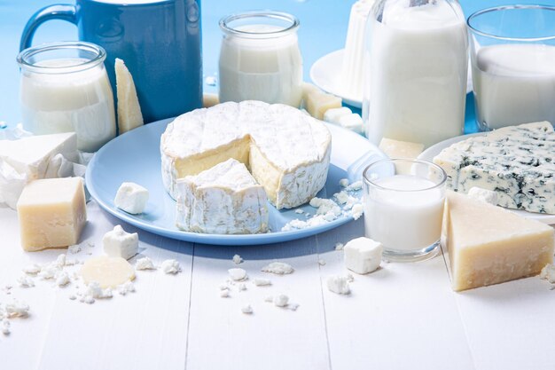 Close up view of dairy products in wooden white background with copy space