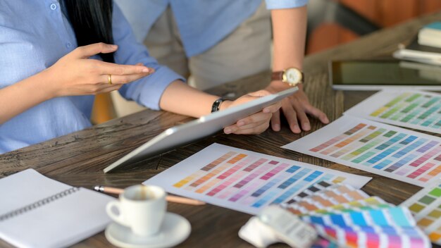 Close up view of designer team consulting for choosing colour for their project