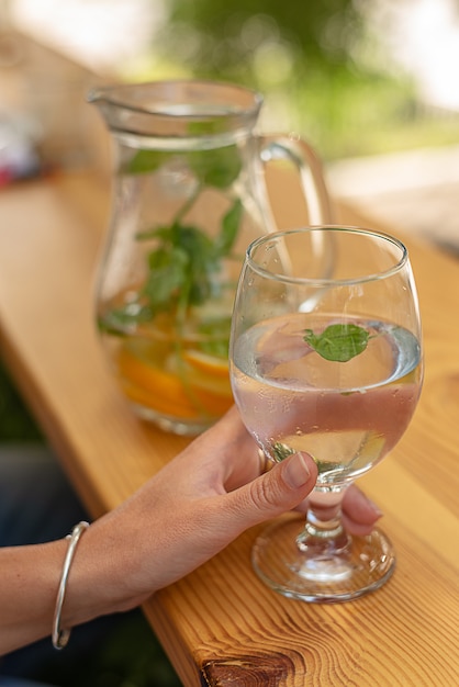 Close-up view of glass of water in female hand