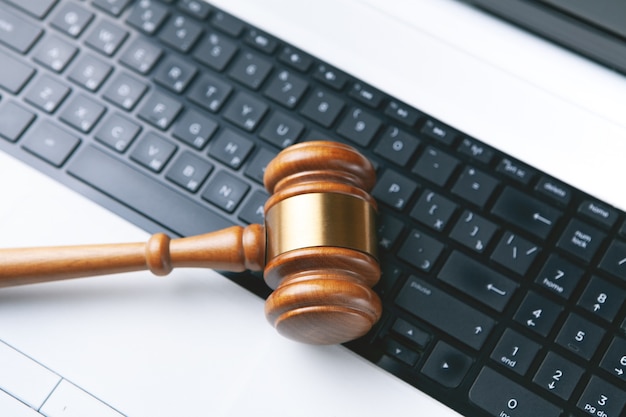 Close up view of a hammer and a computer keyboard.