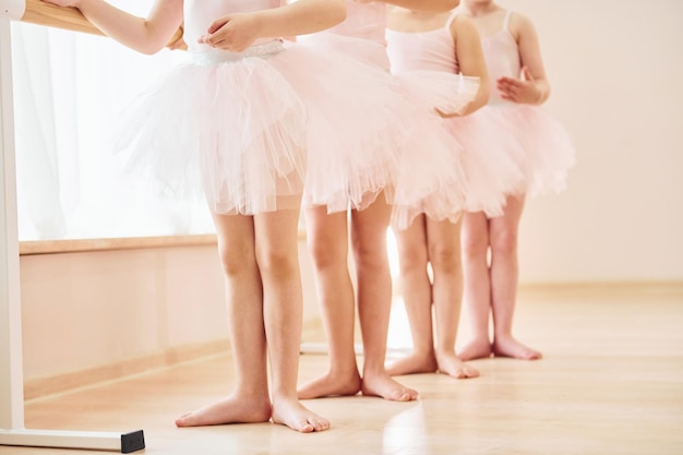 Close up view Little ballerinas preparing for performance by practicing dance moves