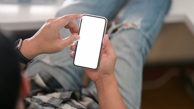 Close up view of man holding mock up smartphone