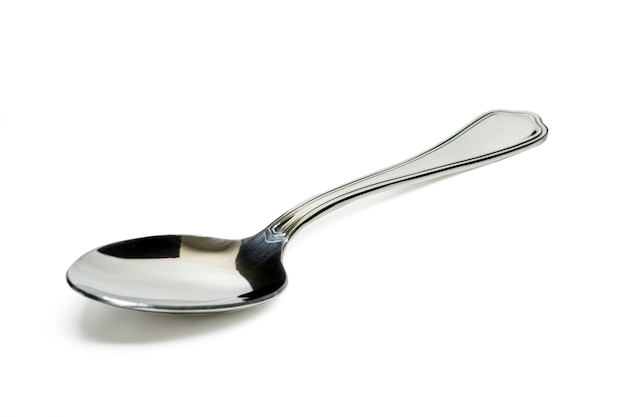 Close up view of a metal spoon for soup isolated on a white background.