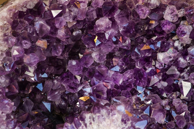 Close up view of a natural violet amethyst crystal geode stone.