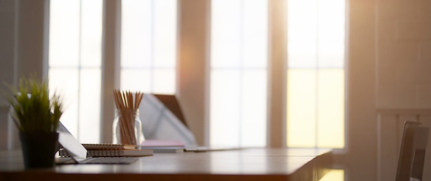 Close up view of portable workspace with computer laptop,  stationery and decoration