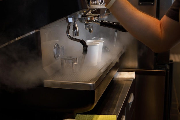 Close up view of preparing coffee espresso in automatic coffee machine in cafe