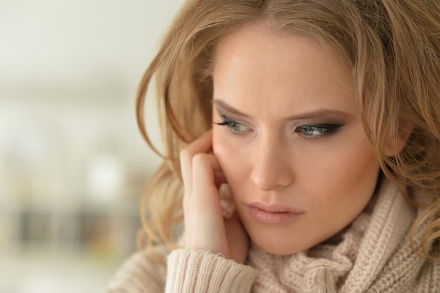 Close up view of sad young woman posing