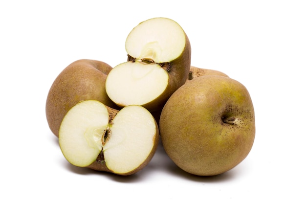 Close up view of several brown apples isolated on a white background.