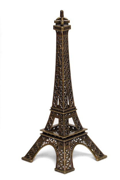 Close up view of a small Eiffel tower statue isolated on a white background.