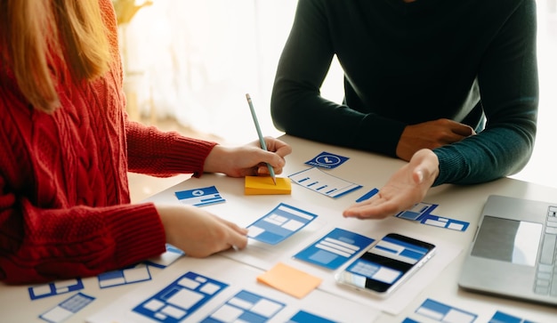 Close up view of UI developer team brainstorming on their project with laptop smartphone and digital tablet Creative digital development agency