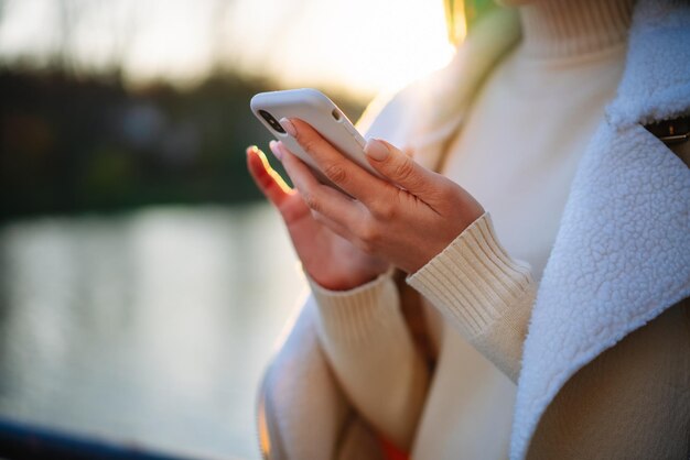 Close up view of woman hands holding phone Lady texting with phone