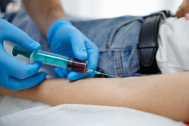 Close up view of woman taking a blood test from a vein in the laboratory