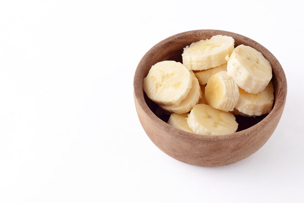 Close up view of wooden bowl with banana slices