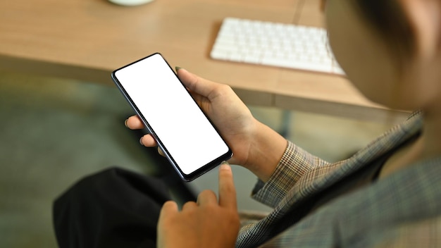 Close up view of working woman hands holding mobile phone Empty display for your advertise text