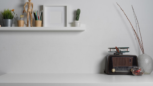 Close up view of worktable with copy space and decorations in white concept in home office room