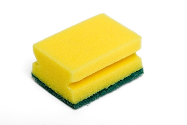 Close up view of a yellow cleaning sponge isolated on a white background.