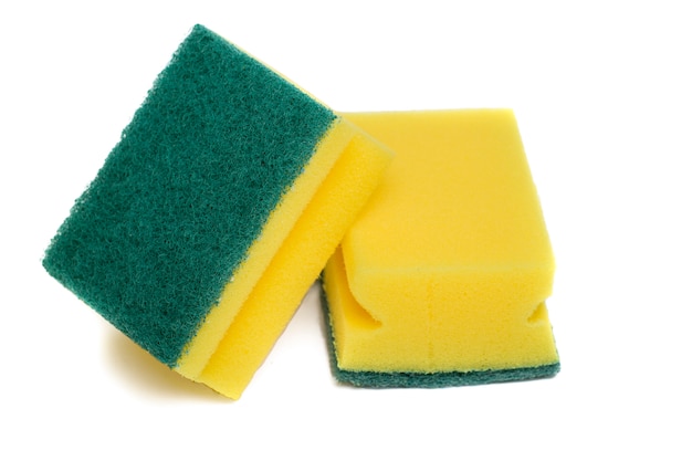 Close up view of a yellow cleaning sponge isolated on a white background.