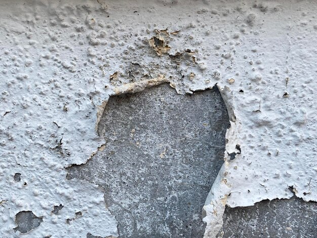 A close up of a wall with a hole in it that says'the word'on it '