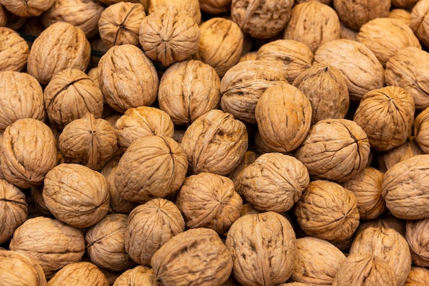 Close up of walnuts on market stall. Dried fruits background concept