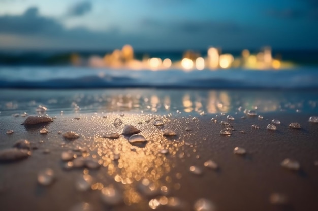 A close up of water on a beach with the lights in the background