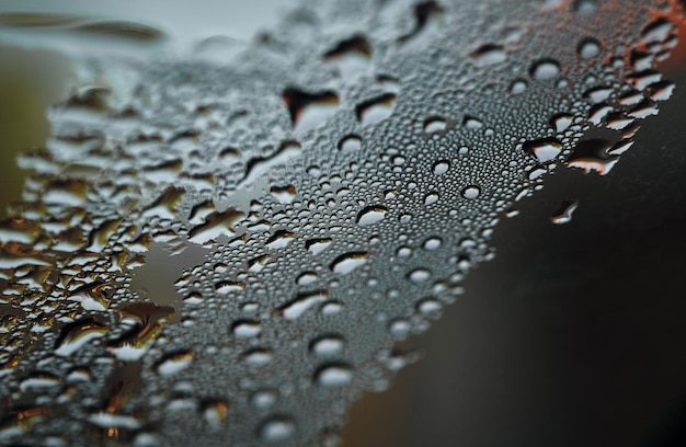 A close up of water droplets on a car window