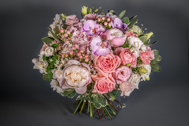 Close up wedding bouquet of flowers Isolated on a gray background Delicate bouquet in pastel colors Summer flowers