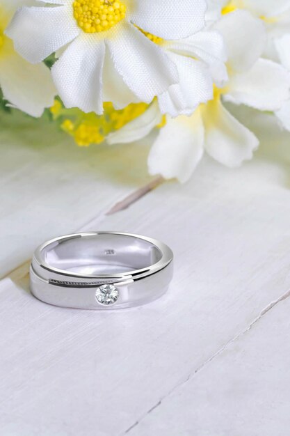 Close-up of wedding rings on white table