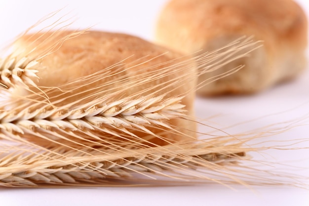 Close up wheat ears and buns in the background