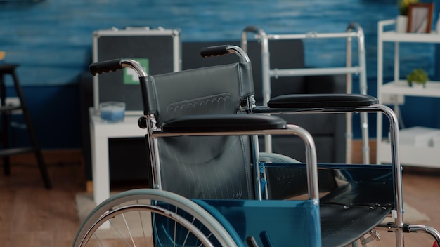 Close up of wheelchair for mobility and transportation in nursing home. Medical chair used for stationary and disabled people, supporting with handicap. Invalidity object in empty room