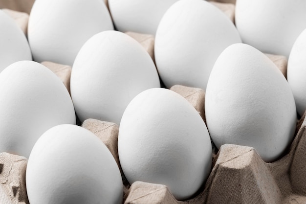 Close-up white eggs in carton