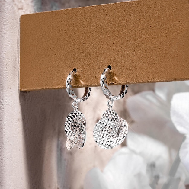 Close-up white gold stud earrings, with white crystals and diamonds. Women Accessories