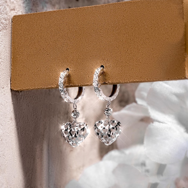 Close-up white gold stud earrings, with white crystals and diamonds. Women Accessories