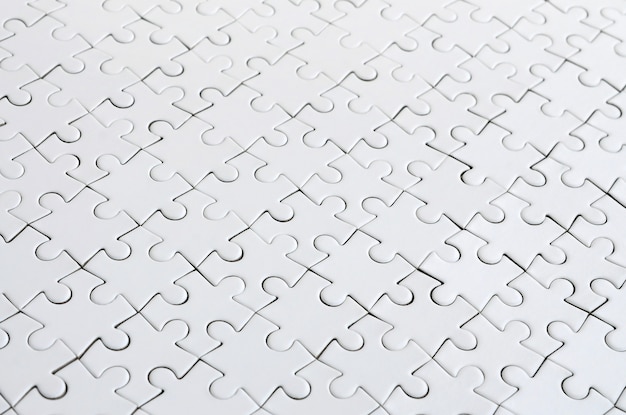 Close up of a white jigsaw puzzle in assembled state in perspective