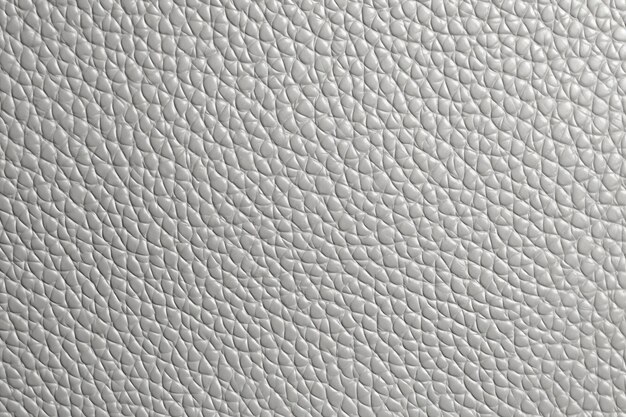 A close up of a white leather texture with a pattern of small squares.